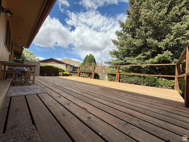 wooden terrace with outdoor dining area