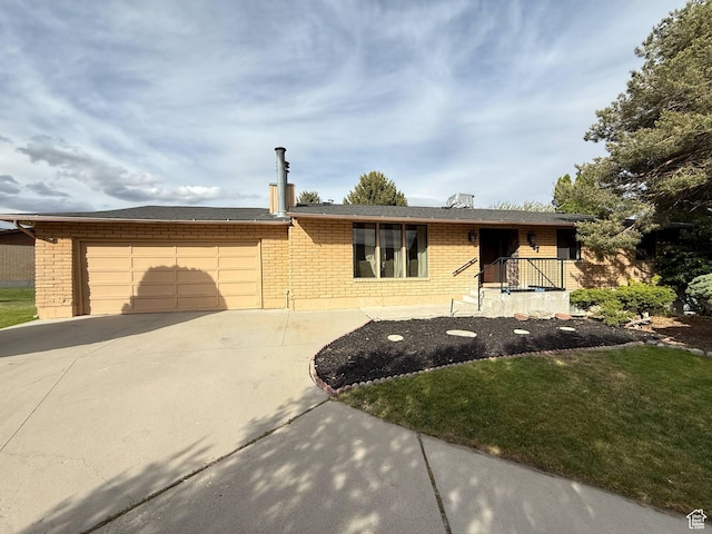 ranch-style home featuring brick siding, driveway, a garage, and a front yard
