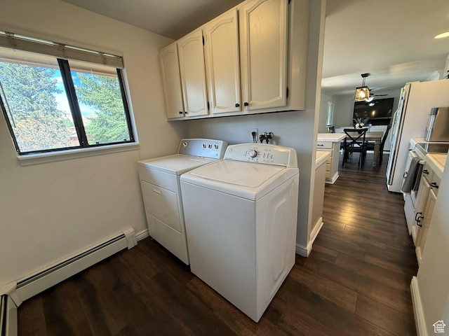 laundry room with washer and clothes dryer, cabinet space, a baseboard heating unit, and dark wood finished floors