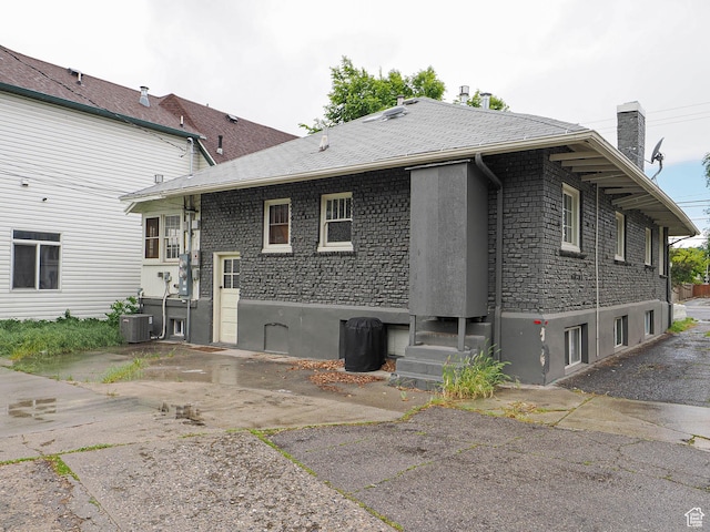 466 N 200 E, Provo, UT 84606 - back of property with central AC unit, a chimney, and stucco siding
