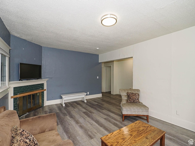 466 N 200 E, Provo, UT 84606 - living room featuring wood finished floors, a textured ceiling, a fireplace, and baseboards