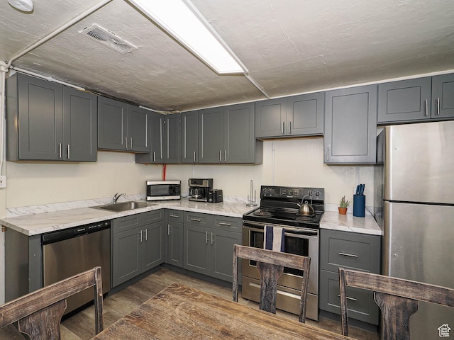 466 N 200 E, Provo, UT 84606 - kitchen with appliances with stainless steel finishes, a sink, light countertops, dark wood finished floors, and gray cabinetry