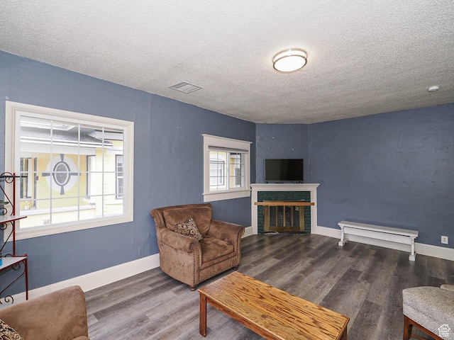 466 N 200 E, Provo, UT 84606 - living area featuring a textured ceiling, wood finished floors, a glass covered fireplace, and baseboards