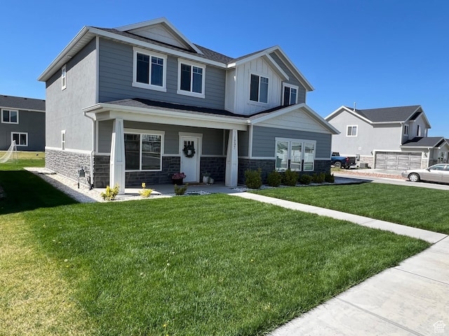 1297 W 450 N, Springville, UT 84663 - craftsman house featuring stone siding, covered porch, a front yard, and board and batten siding