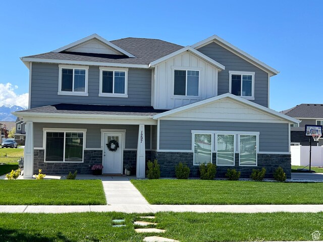 1297 W 450 N, Springville, UT 84663 - craftsman-style home with stone siding, a front lawn, board and batten siding, and roof with shingles