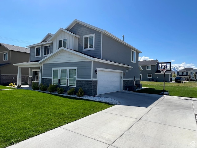 1297 W 450 N, Springville, UT 84663 - view of front of house with stone siding, concrete driveway, a front yard, a garage, and board and batten siding