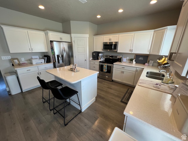 1297 W 450 N, Springville, UT 84663 - kitchen featuring stainless steel appliances, a center island, white cabinetry, a breakfast bar area, and recessed lighting