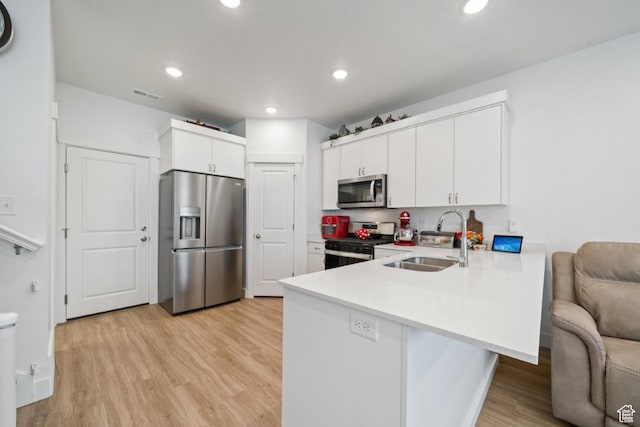 968 W 960 N Unit T3, Tremonton, UT 84337 - kitchen featuring stainless steel appliances, a sink, a peninsula, light wood-style floors, and light countertops