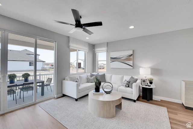 4053 W 2025 S Unit 40, Taylor, UT 84401 - living room featuring a ceiling fan, light wood-style flooring, baseboards, recessed lighting, and a textured ceiling