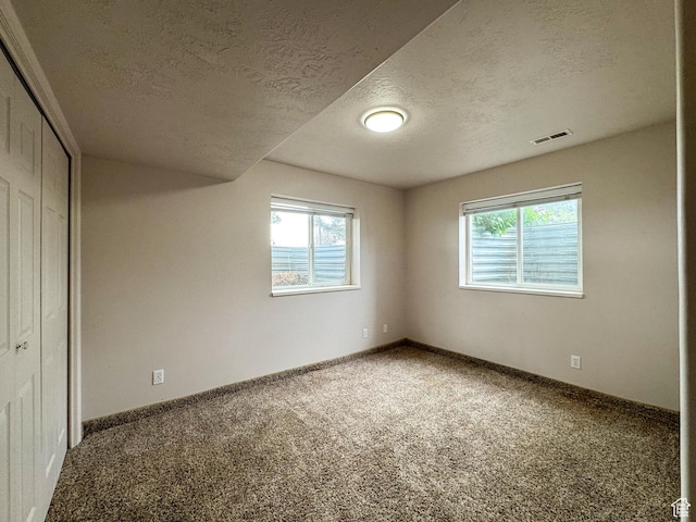 619 W 225 S, Layton, UT 84041 - unfurnished bedroom featuring a textured ceiling, multiple windows, carpet, a closet, and baseboards