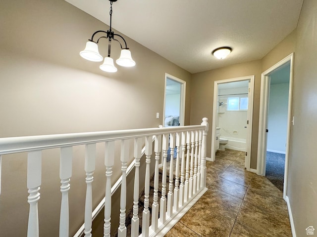 619 W 225 S, Layton, UT 84041 - hallway with a chandelier, an upstairs landing, tile patterned floors, and baseboards