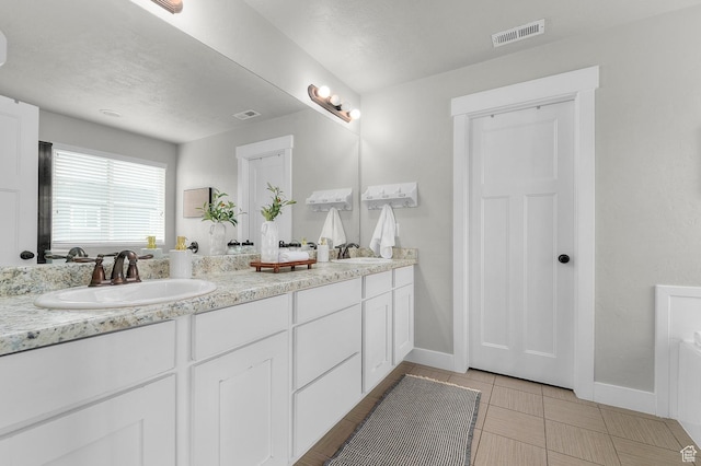 2258 W Falconer Cir, Farmington, UT 84025 - bathroom featuring baseboards and double vanity