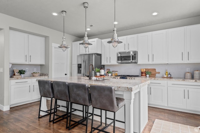 2258 W Falconer Cir, Farmington, UT 84025 - kitchen featuring stainless steel appliances, an island with sink, dark wood-style flooring, tasteful backsplash, and recessed lighting