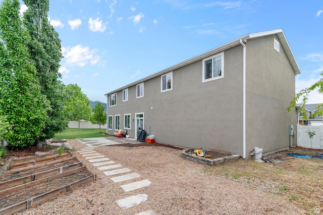 2258 W Falconer Cir, Farmington, UT 84025 - rear view of property with fence, stucco siding, and a patio area