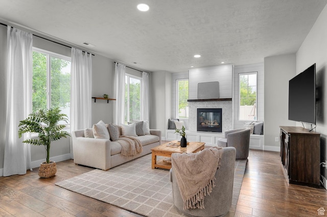 2258 W Falconer Cir, Farmington, UT 84025 - living area with recessed lighting, hardwood / wood-style flooring, a large fireplace, baseboards, and plenty of natural light