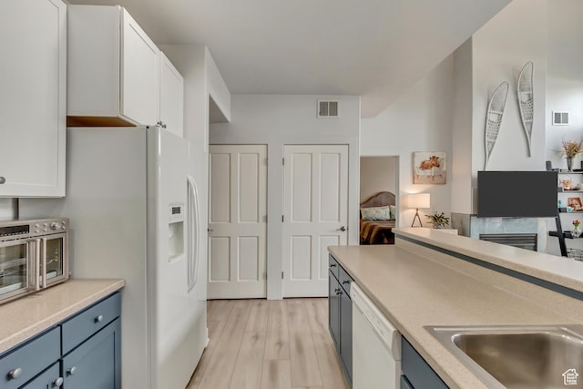 6641 N 2200 W Unit D-304, Park City, UT 84098 - kitchen featuring white appliances, white cabinetry, light countertops, and a sink
