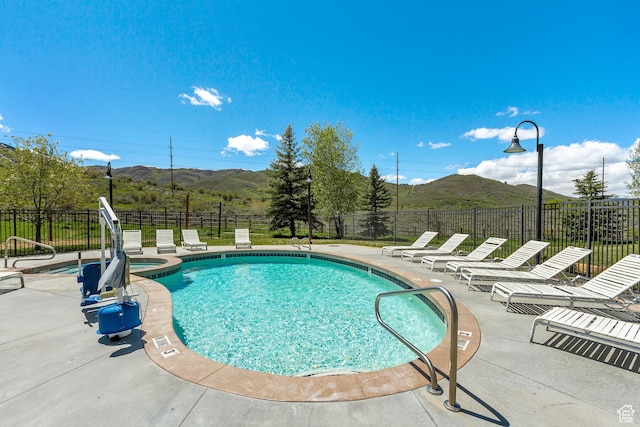 6641 N 2200 W Unit D-304, Park City, UT 84098 - view of pool featuring a mountain view, a patio, and a pool with connected hot tub