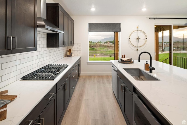 1513 E 820 N Unit 105, Salem, UT 84653 - kitchen with a sink, wall chimney exhaust hood, gas cooktop, stainless steel dishwasher, and baseboards