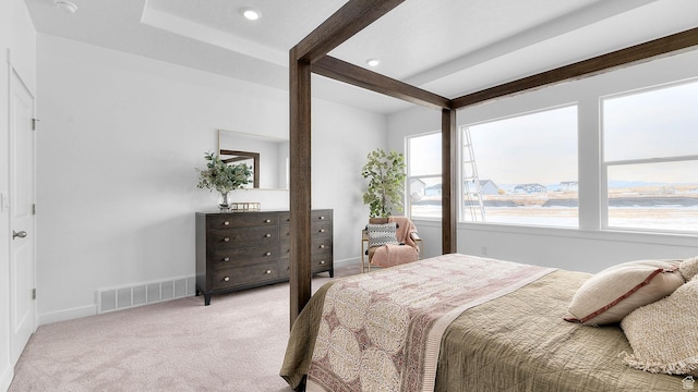 bedroom featuring multiple windows, light carpet, baseboards, beam ceiling, and recessed lighting