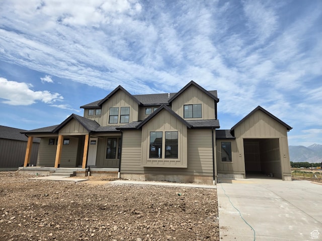 1513 E 820 N Unit 105, Salem, UT 84653 - view of front of property with board and batten siding, a porch, concrete driveway, and a shingled roof