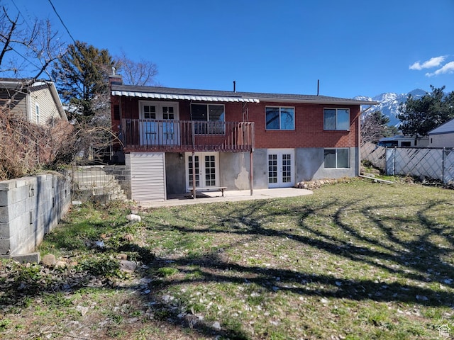 rear view of house with french doors, a patio, and a wooden deck