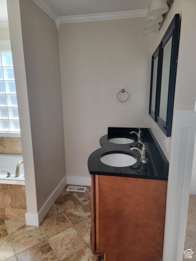 full bath with crown molding, baseboards, a garden tub, and double vanity