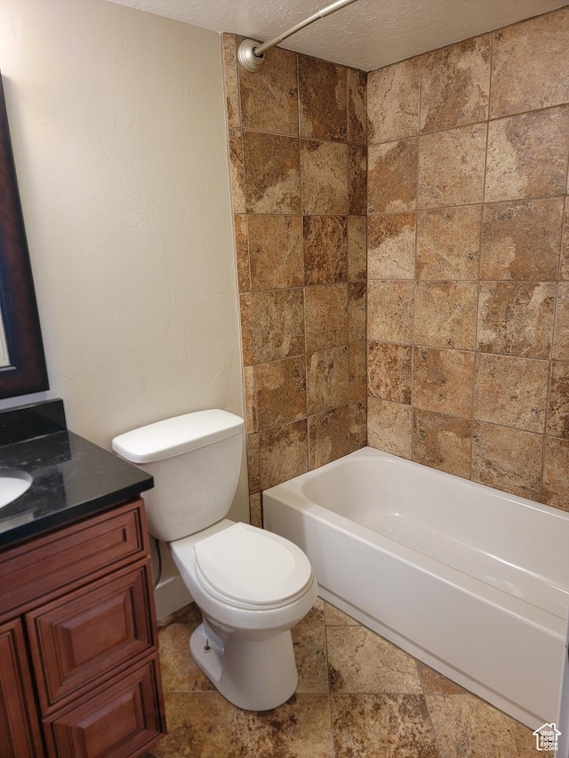 bathroom featuring toilet, vanity, a textured ceiling, and tub / shower combination