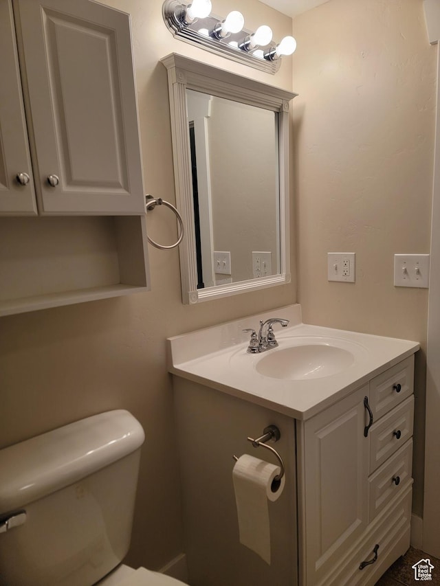 half bathroom with toilet and vanity