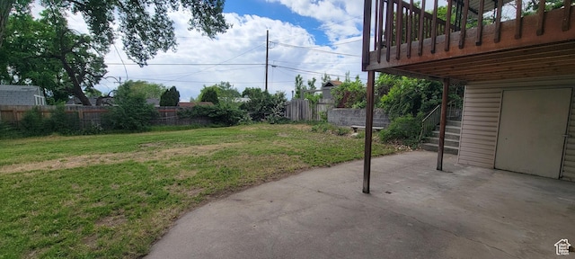 view of yard featuring a patio area and stairs