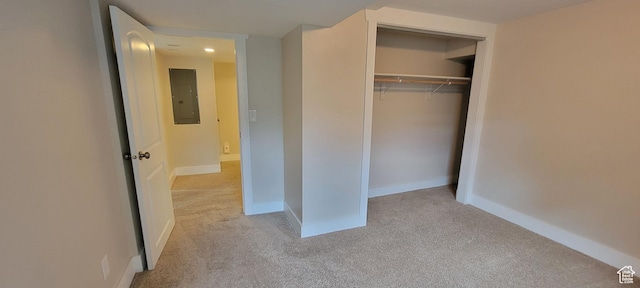 unfurnished bedroom featuring carpet floors, electric panel, a closet, baseboards, and recessed lighting