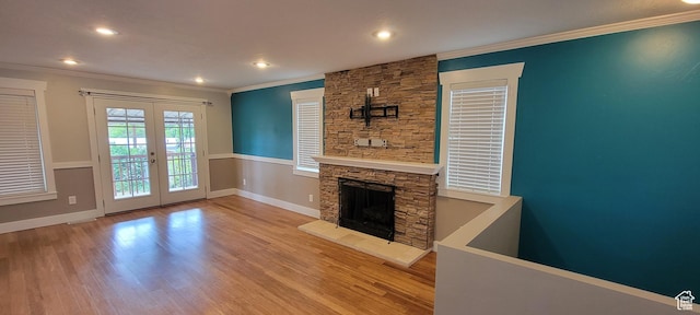 unfurnished living room with ornamental molding, french doors, recessed lighting, wood finished floors, and baseboards