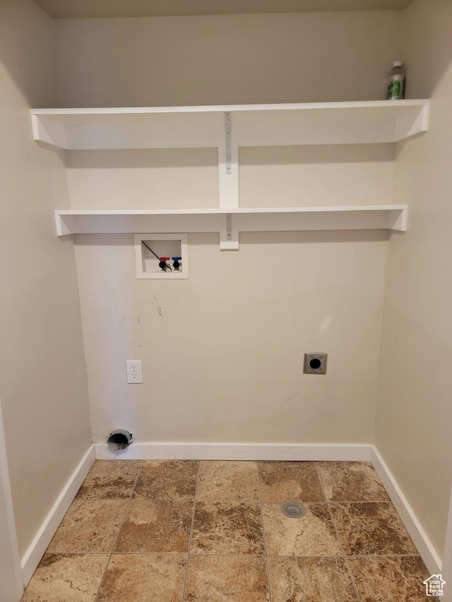 laundry area featuring hookup for a washing machine, electric dryer hookup, baseboards, and stone finish floors