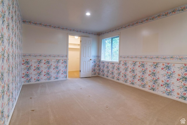 unfurnished room with carpet flooring, wallpapered walls, recessed lighting, baseboards, and a wainscoted wall
