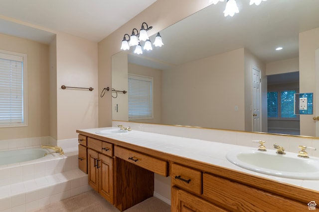bathroom featuring double vanity and a garden tub