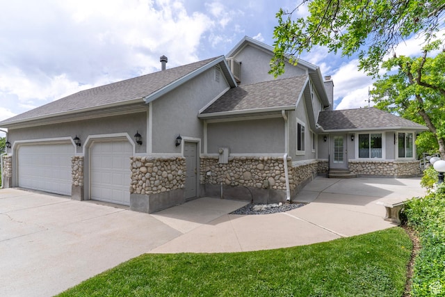 view of front of home with stucco siding, stone siding, roof with shingles, concrete driveway, and entry steps