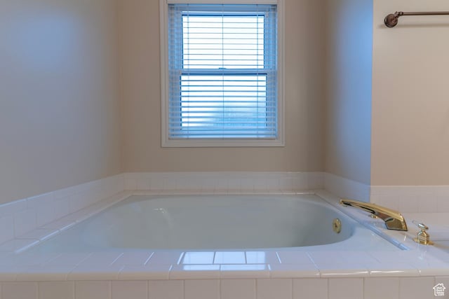 full bath with healthy amount of natural light and a garden tub
