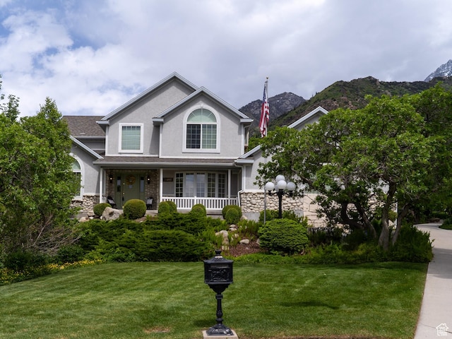 2485 E Stonebrook Cir, Sandy, UT 84092 - traditional-style home featuring stone siding, a porch, stucco siding, and a front yard