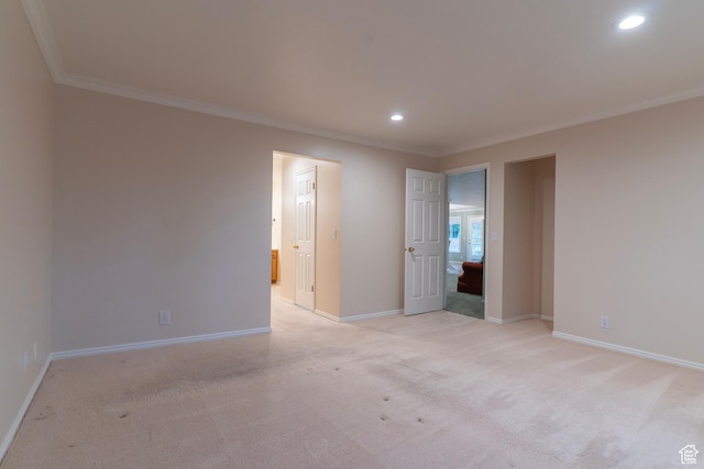 spare room with ornamental molding, recessed lighting, baseboards, and light carpet