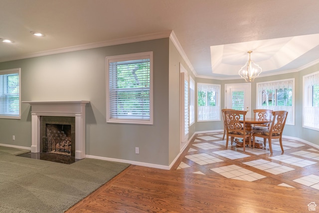 dining room featuring baseboards, plenty of natural light, a fireplace with flush hearth, a chandelier, and recessed lighting