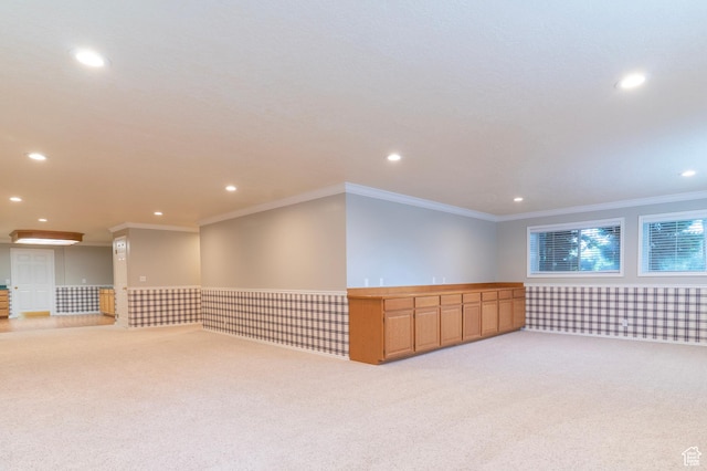 empty room with light carpet, recessed lighting, and crown molding