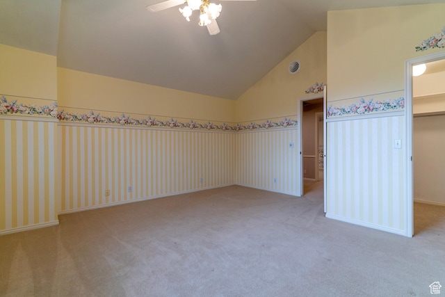 unfurnished bedroom with carpet floors, a spacious closet, high vaulted ceiling, ceiling fan, and a closet
