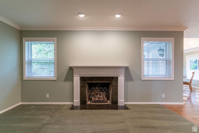 unfurnished living room featuring crown molding, baseboards, a high end fireplace, and recessed lighting