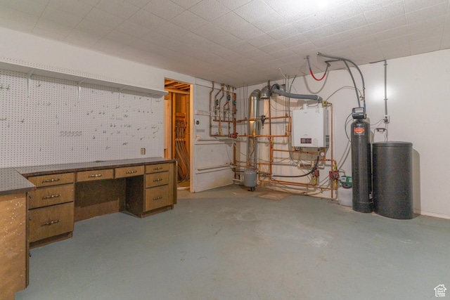 unfinished basement featuring a workshop area, tankless water heater, and a water softener