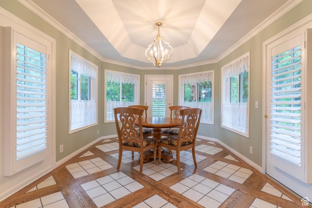 dining area with plenty of natural light, a chandelier, and baseboards