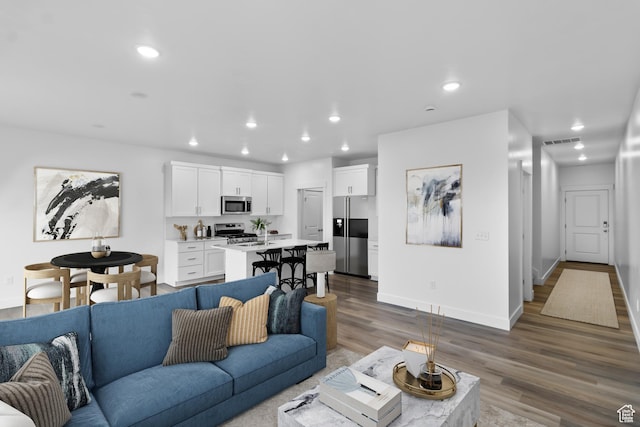 651 W 575 N, Smithfield, UT 84335 - living area with wood finished floors, recessed lighting, and baseboards