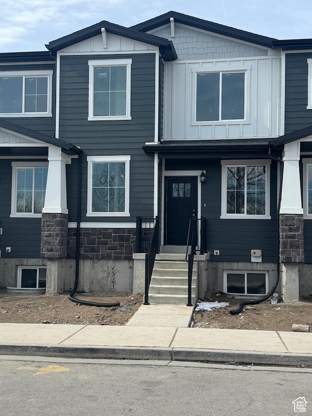 view of front of property featuring stone siding and board and batten siding