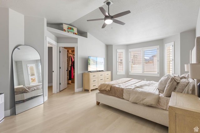 541 W 1960 N, Tooele, UT 84074 - bedroom featuring light wood-type flooring, a walk in closet, vaulted ceiling, baseboards, and a closet