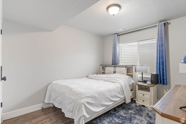 541 W 1960 N, Tooele, UT 84074 - bedroom featuring baseboards, dark wood-style floors, and a textured ceiling