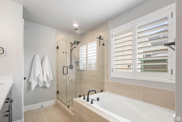 541 W 1960 N, Tooele, UT 84074 - bathroom with a shower stall, a bath, vanity, and baseboards