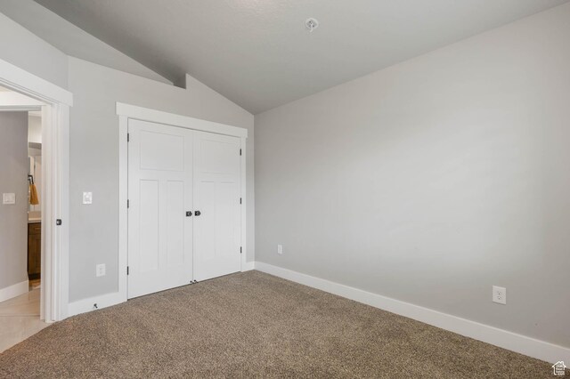 541 W 1960 N, Tooele, UT 84074 - unfurnished bedroom featuring lofted ceiling, light carpet, baseboards, and a closet